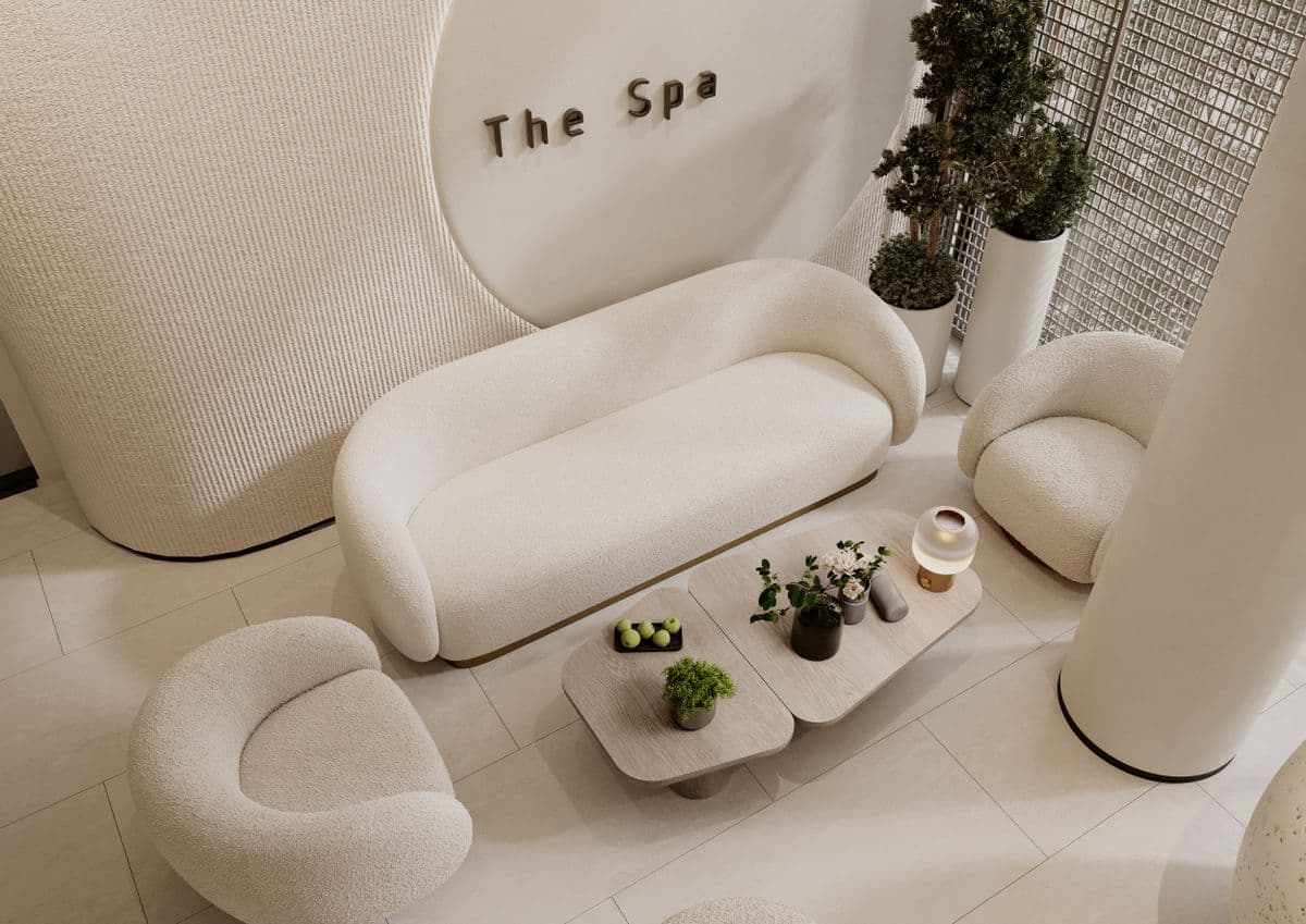 Area lounge con divano bouclé color avorio e insegna luminosa The Spa
